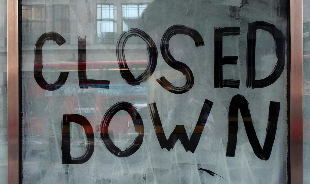 marco-bianchetti-ENHHeSeQuSw-unsplash-1024×609 Hand painted “Closed Down” sign on a storefront window with reflections of the street outside